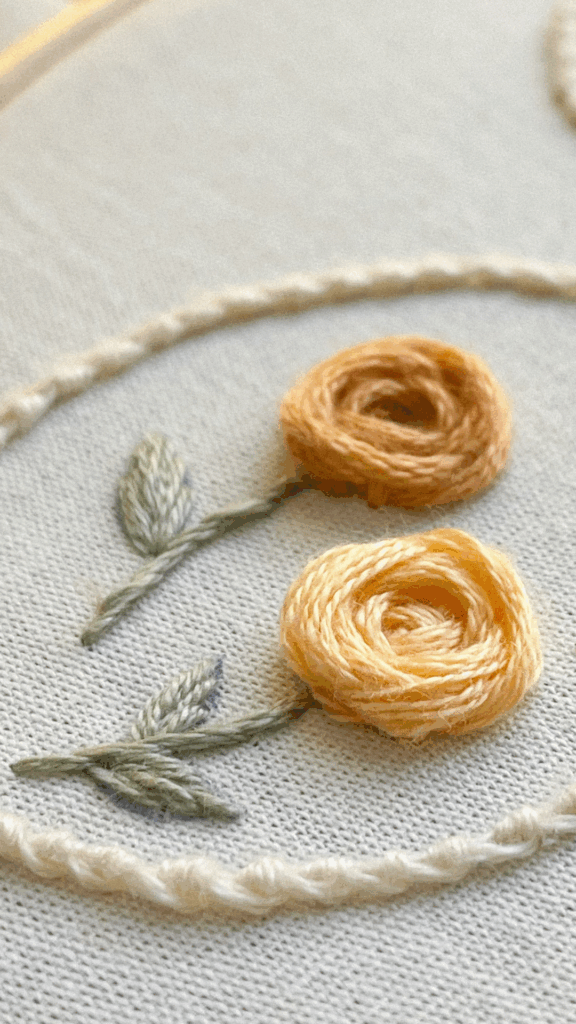 Rosas amarelas bordadas com pontos de volume